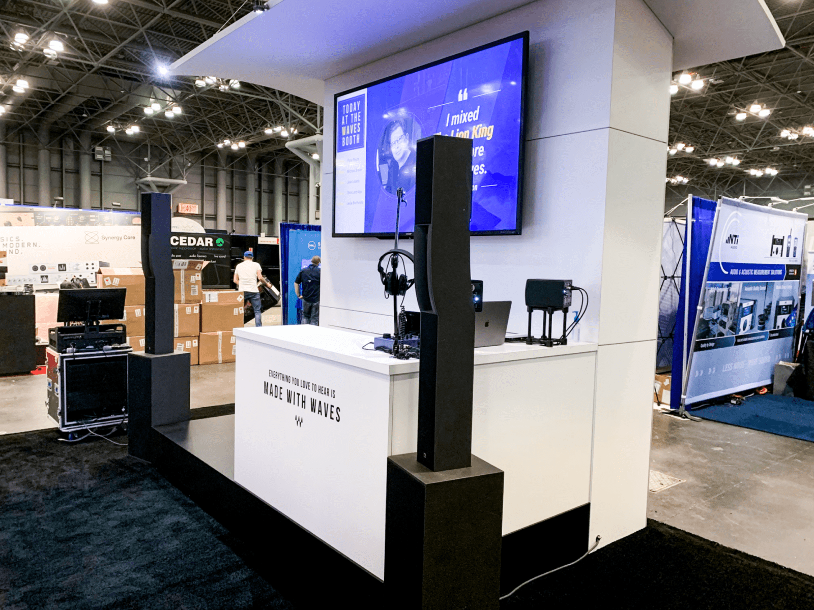 Waves Exhibit Trader Booth (7) Custom curved extrusion wave floating over trade show booth made of custom millwork
